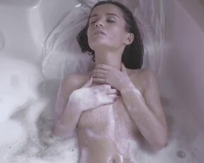 Girl enjoys the foam in her bath