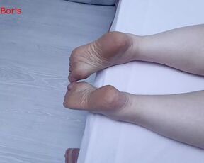 Anna shows the soles of her feet on the bed. Will you like it?