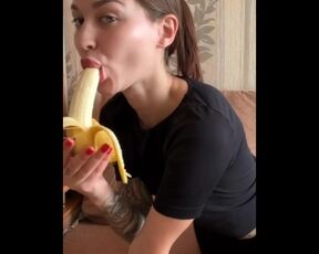 beautiful student licks her juicy banana in front of the camera